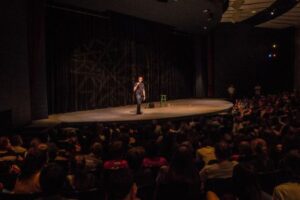 Youth speaker Jeff Veley on stage with audience.